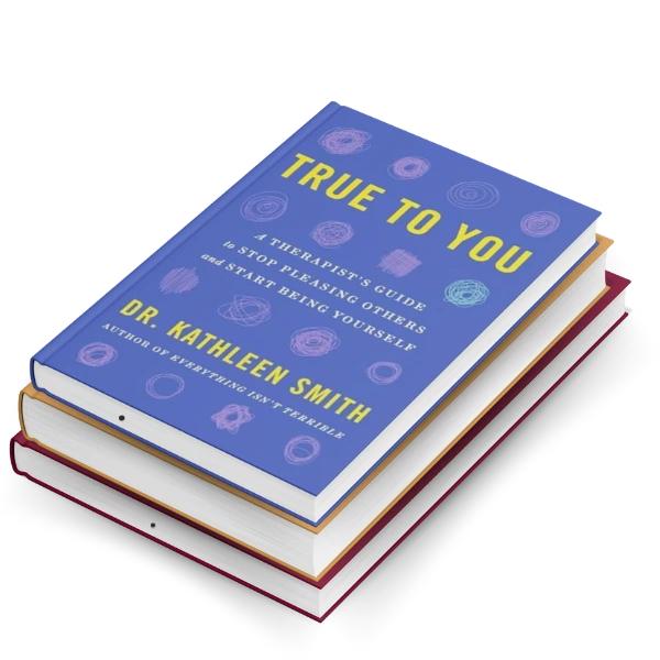 True to You self-help book with blue cover stacked on red-spined books. Attractive book display featuring personal development title.