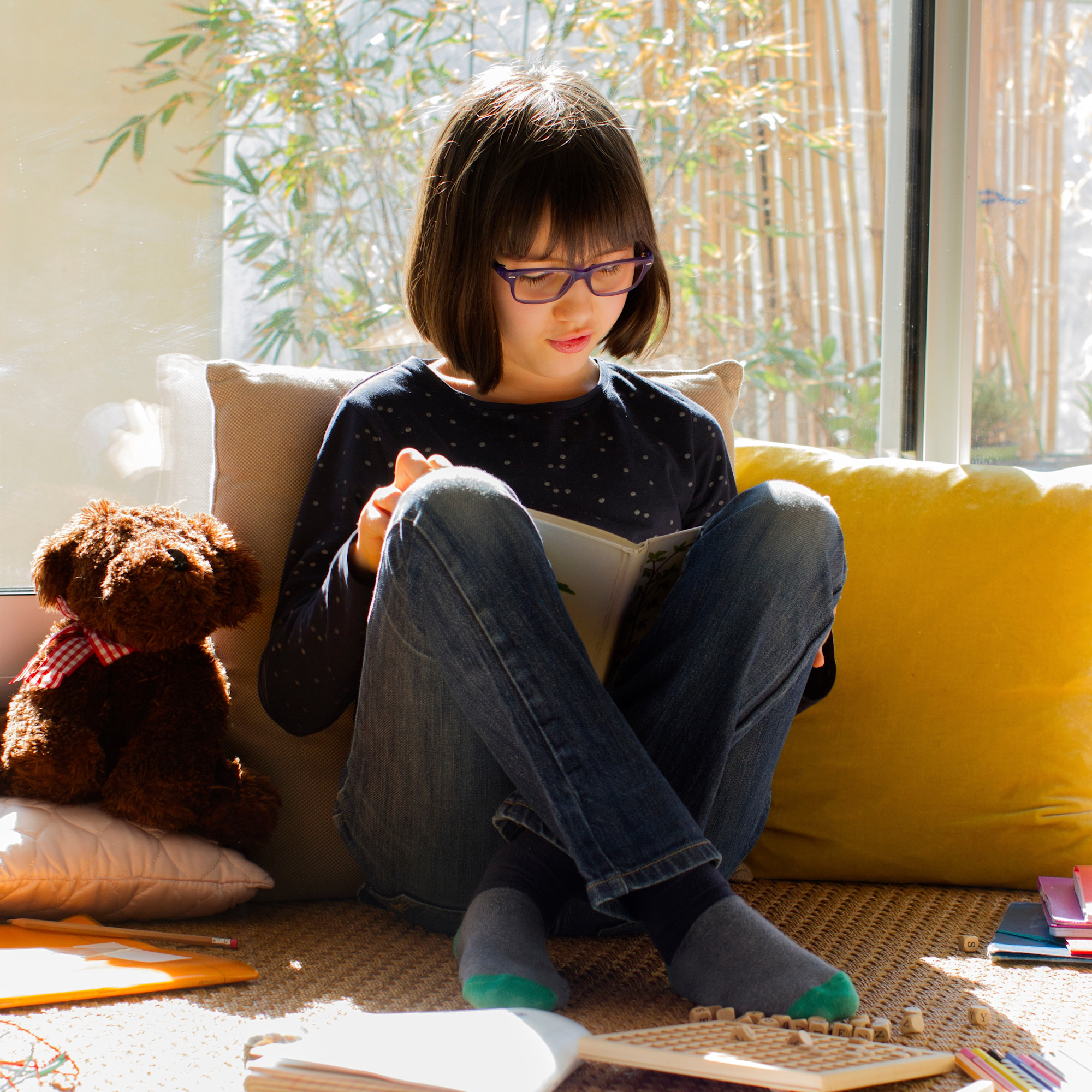 Girl sitting on floor reading a book