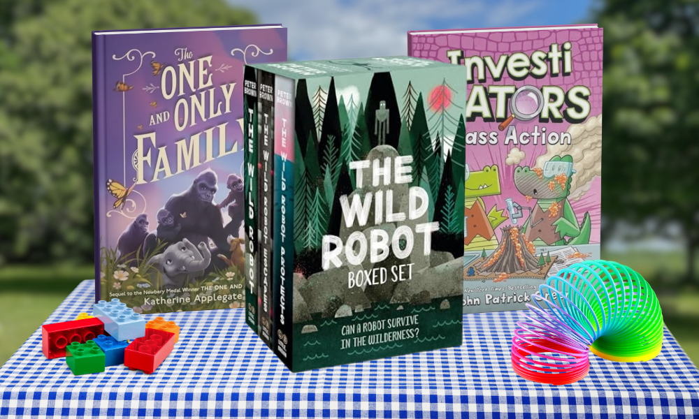 Three Series for Summer displayed on blue checkered tablecloth: The One and Only Family by Katherine Applegate (purple cover with gorillas), The Wild Robot Boxed Set (green forest-themed set), and InvestiGATORS Class Action by John Patrick Green (pink cover with alligator characters). Colorful building blocks and rainbow slinky toys arranged alongside books.