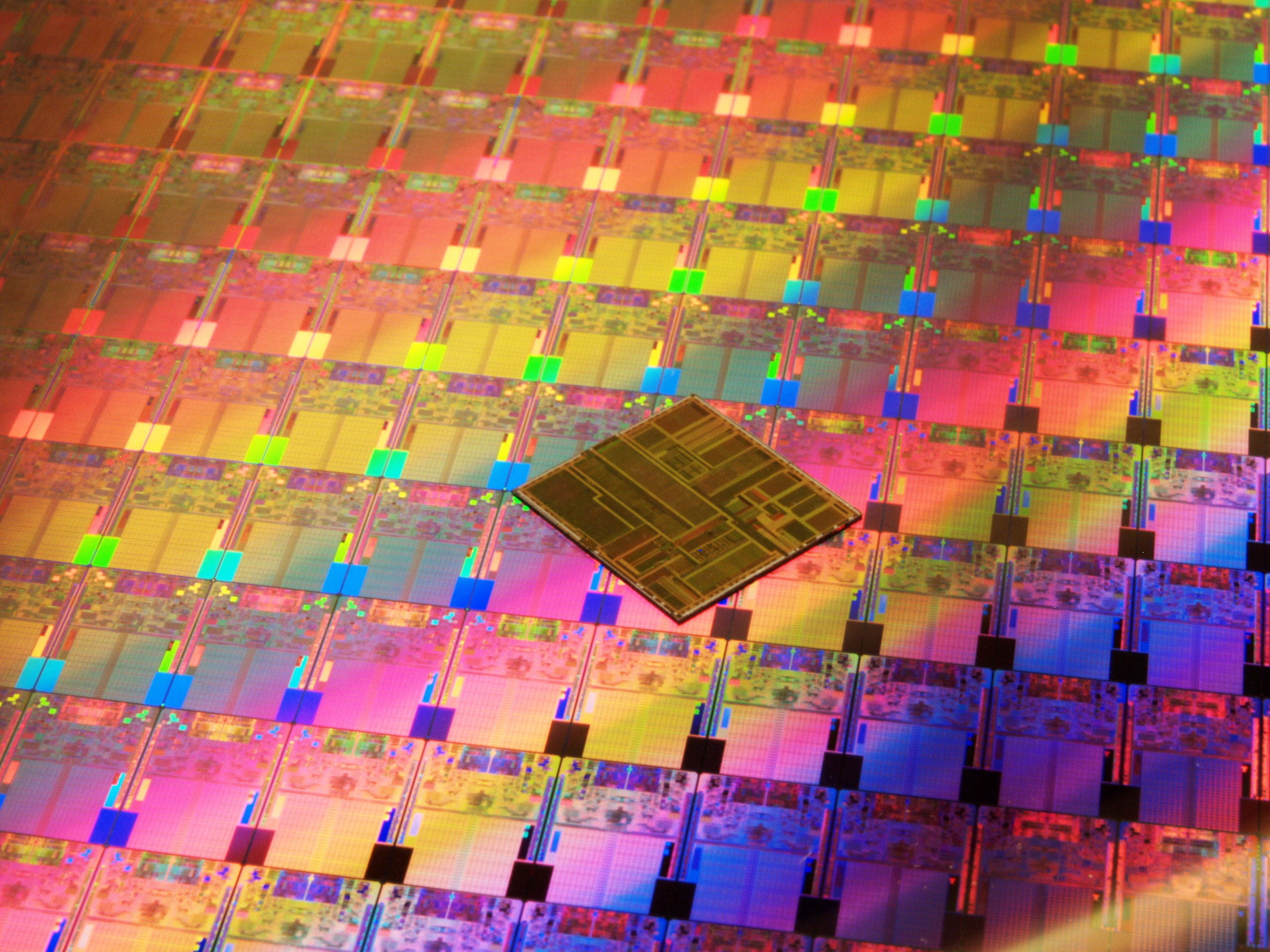 A Pentium chip placed on top of a wafer of 45nm chips made using high-k, metal gate transistor technology shows how much smaller the new generation of chip was, even as it contained far more processing power. 