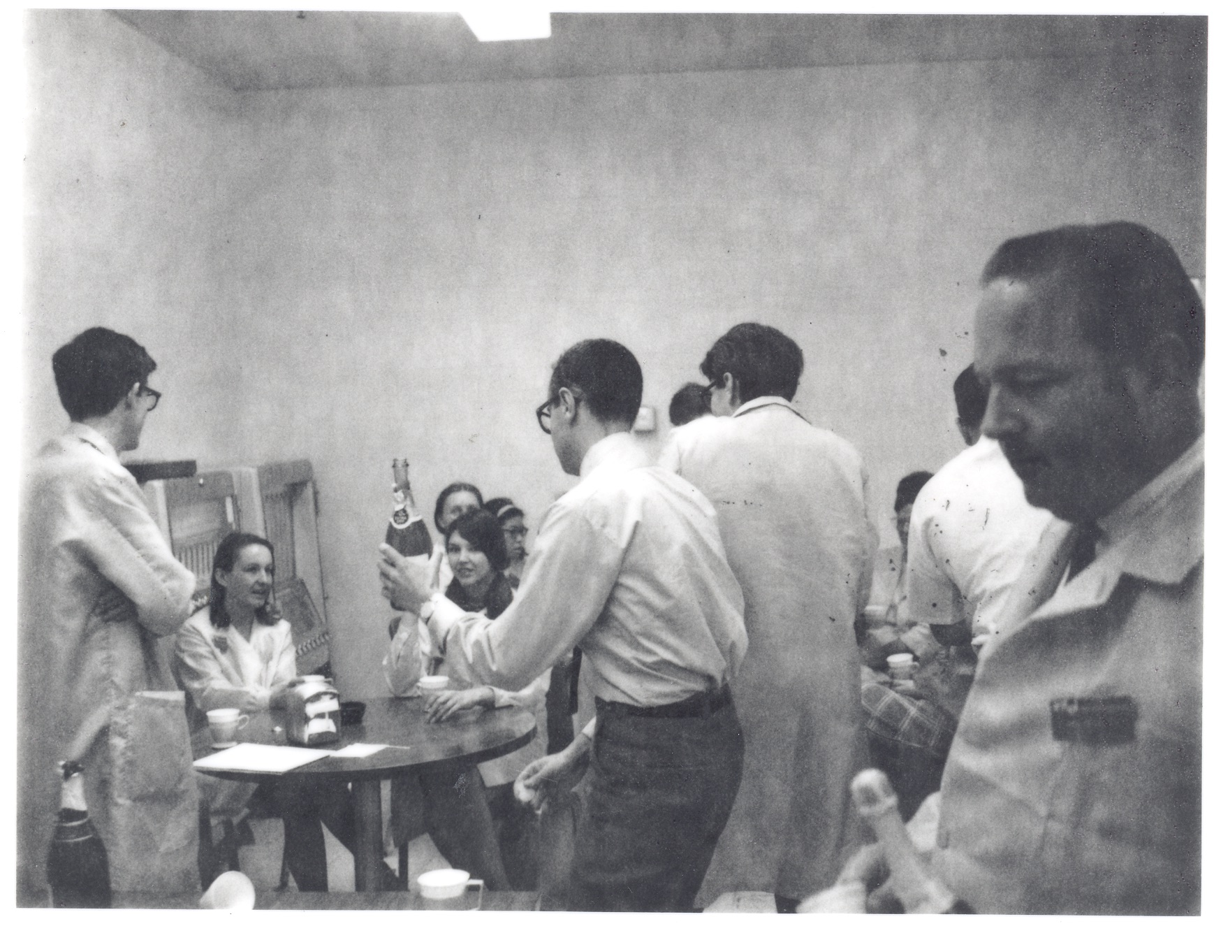 Andy Grove (center) passes around the champagne as Intel celebrates the breakthrough potential of its new 1103 DRAM. 