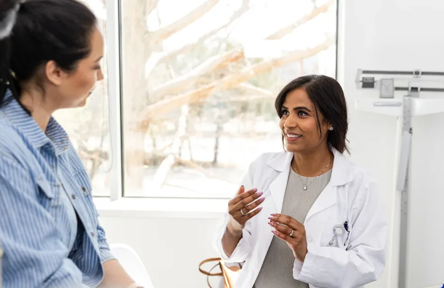 A doctor discussing with a patient in a doctor's office.