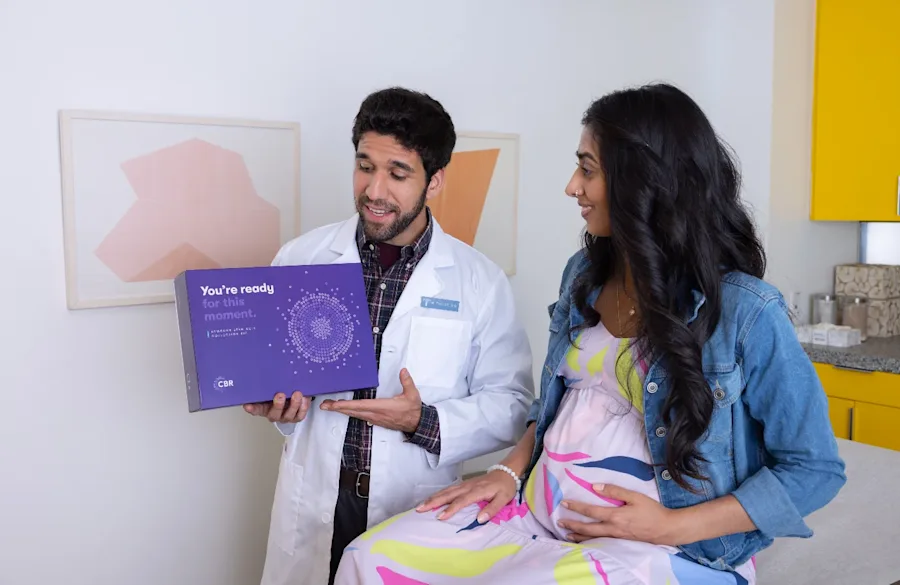 A medical professional discussing medical options with a patient in an office.