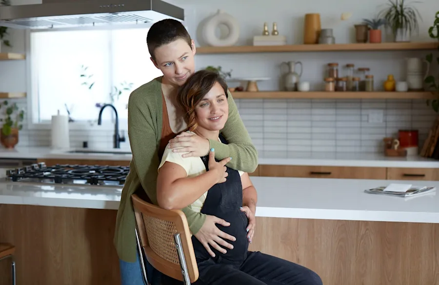 A couple embracing each other while smiling.