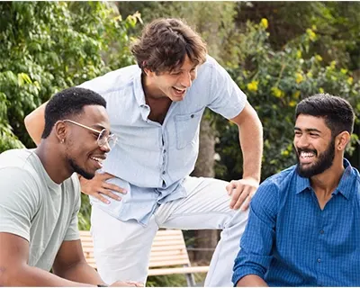 Three men talking and laughing.