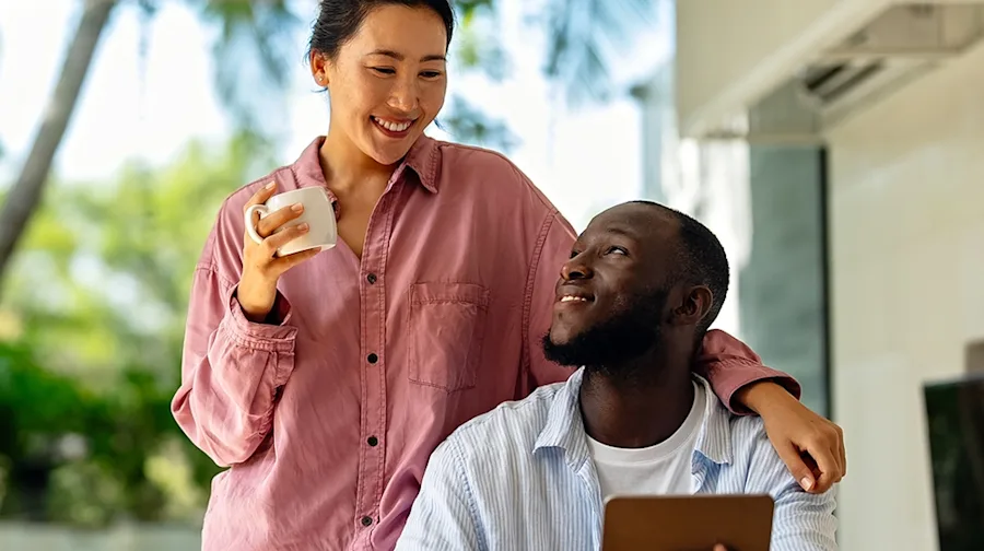 A couple sitting outside enjoying a cup of coffee. 