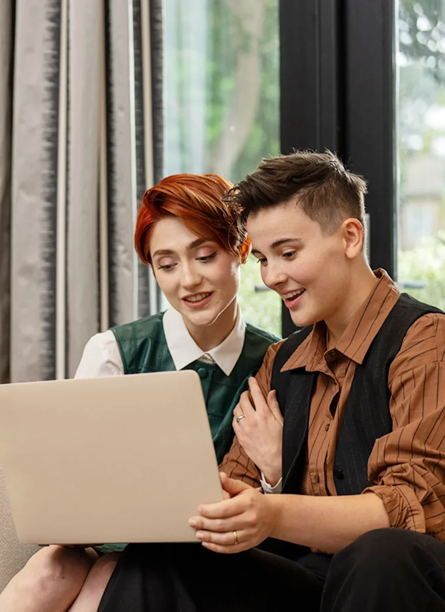Couple looking at a computer screen together.
