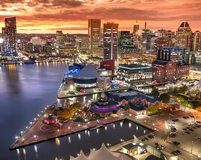 An evening view of a city and lights next to a body of water.