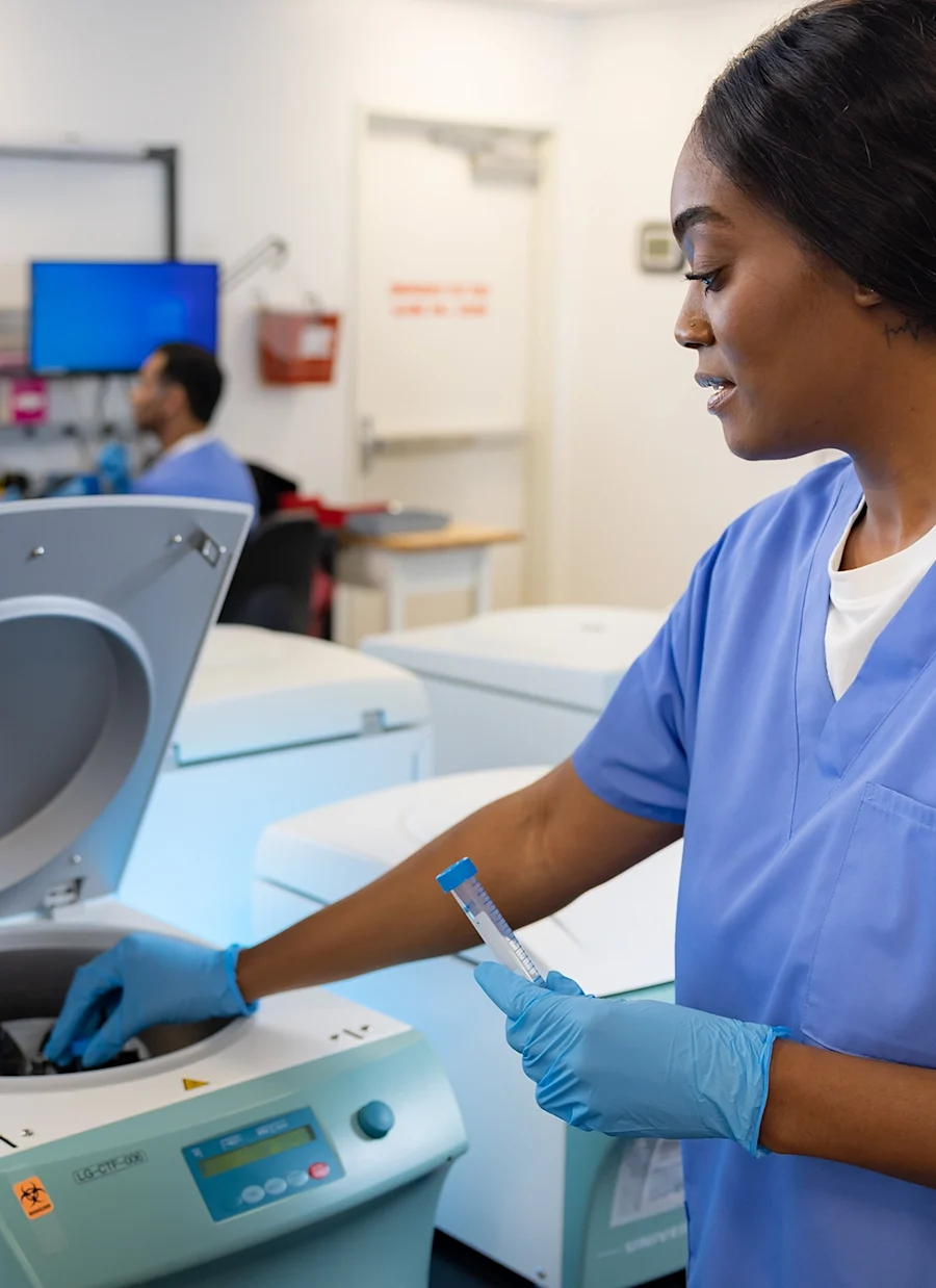 A medical professional handling vials.