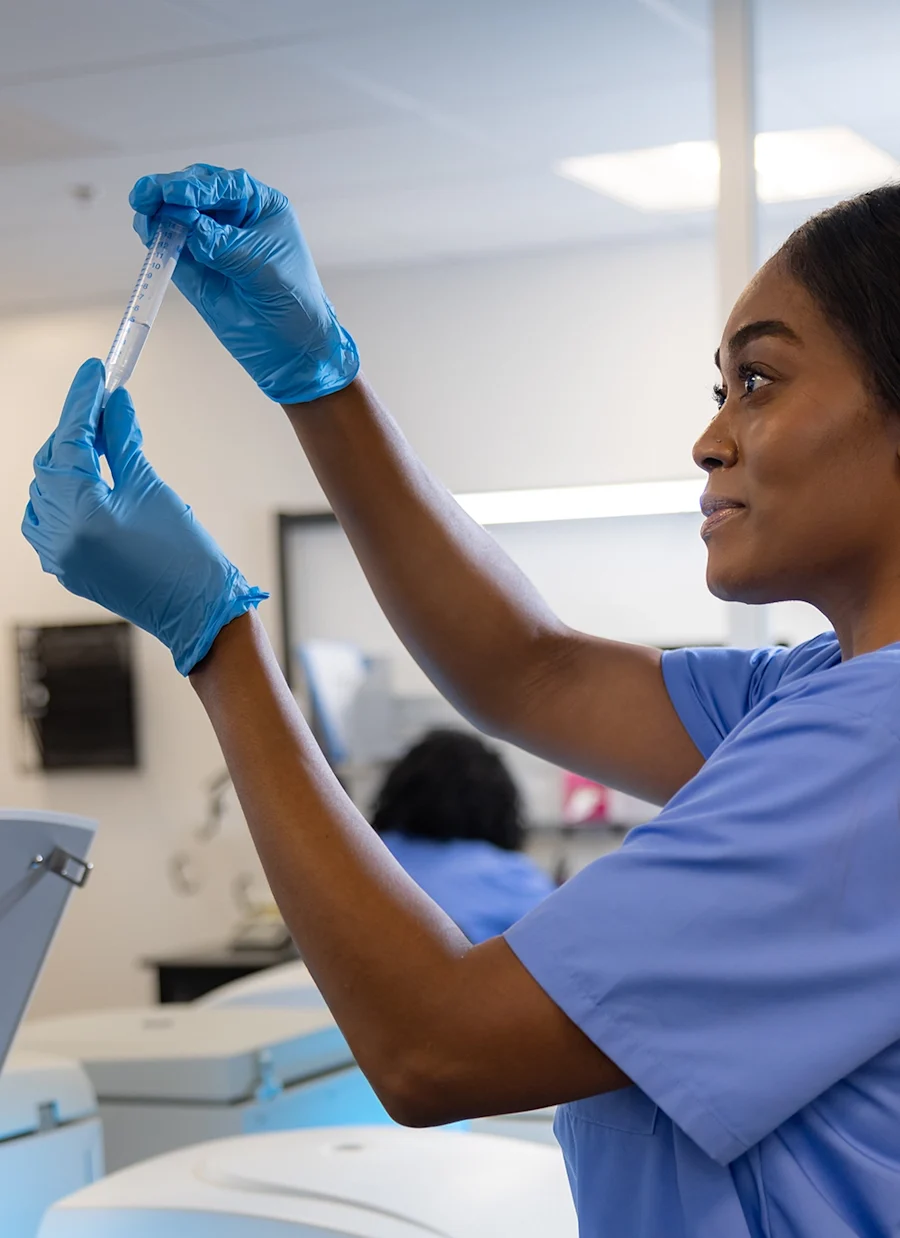 Woman reviewing specimen in a lab.