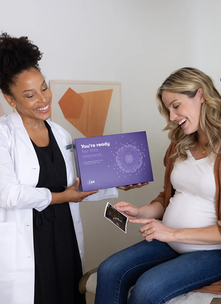 Two people interacting in a medical office smiling.