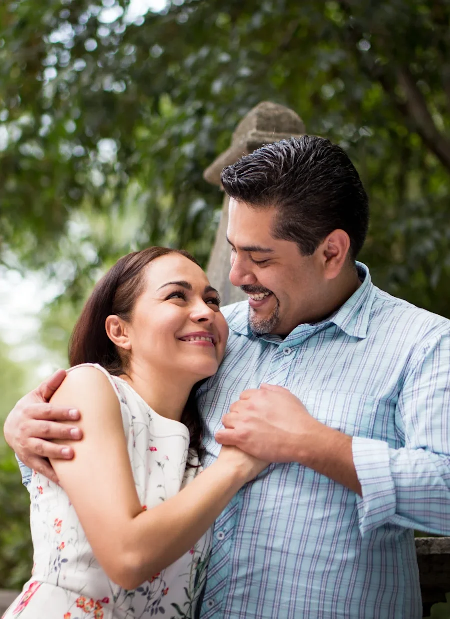 A couple embracing and smiling.