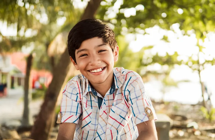 A child outside with a big smile.
