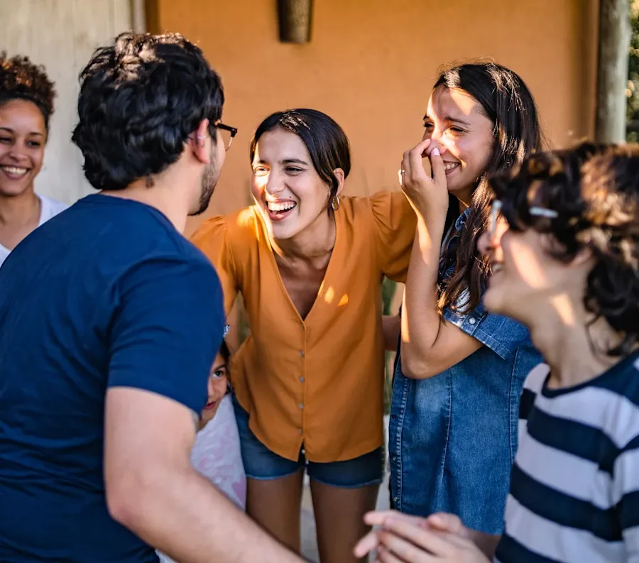 A group of friends laughing while talking together.