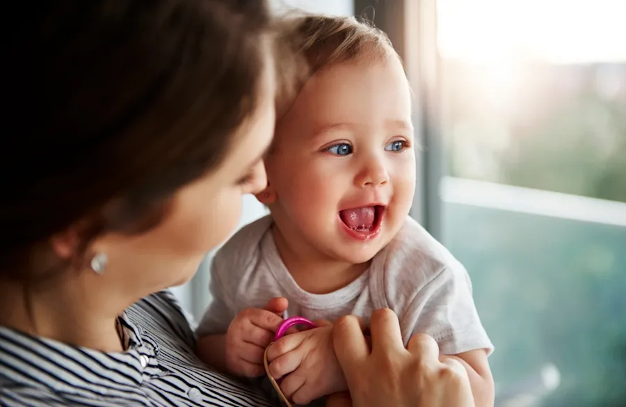 A mother holding a smiling baby.