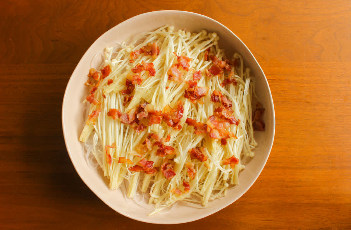 Layered enoki mushrooms and bacon
