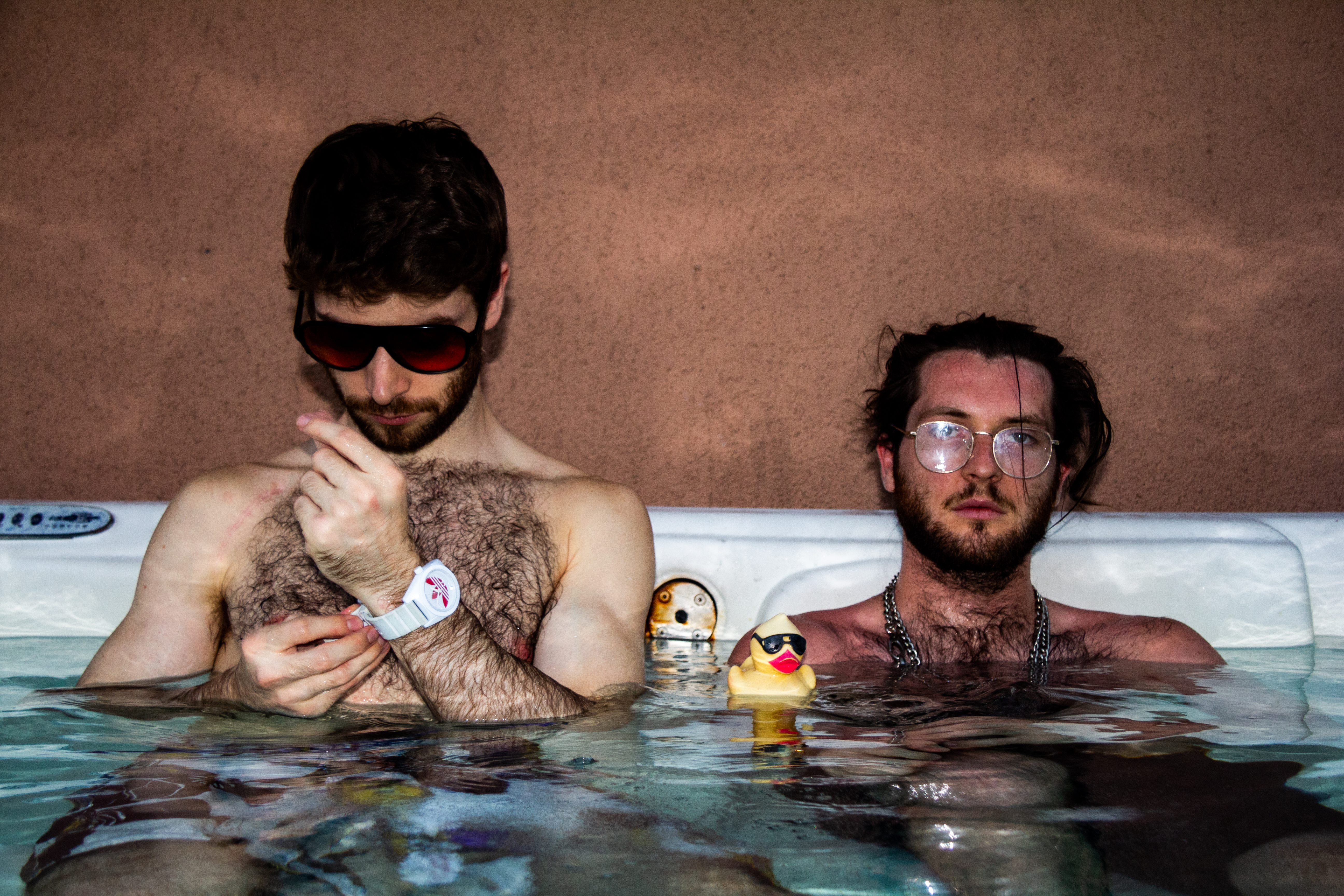 A photograph of two boys in a hot tub.