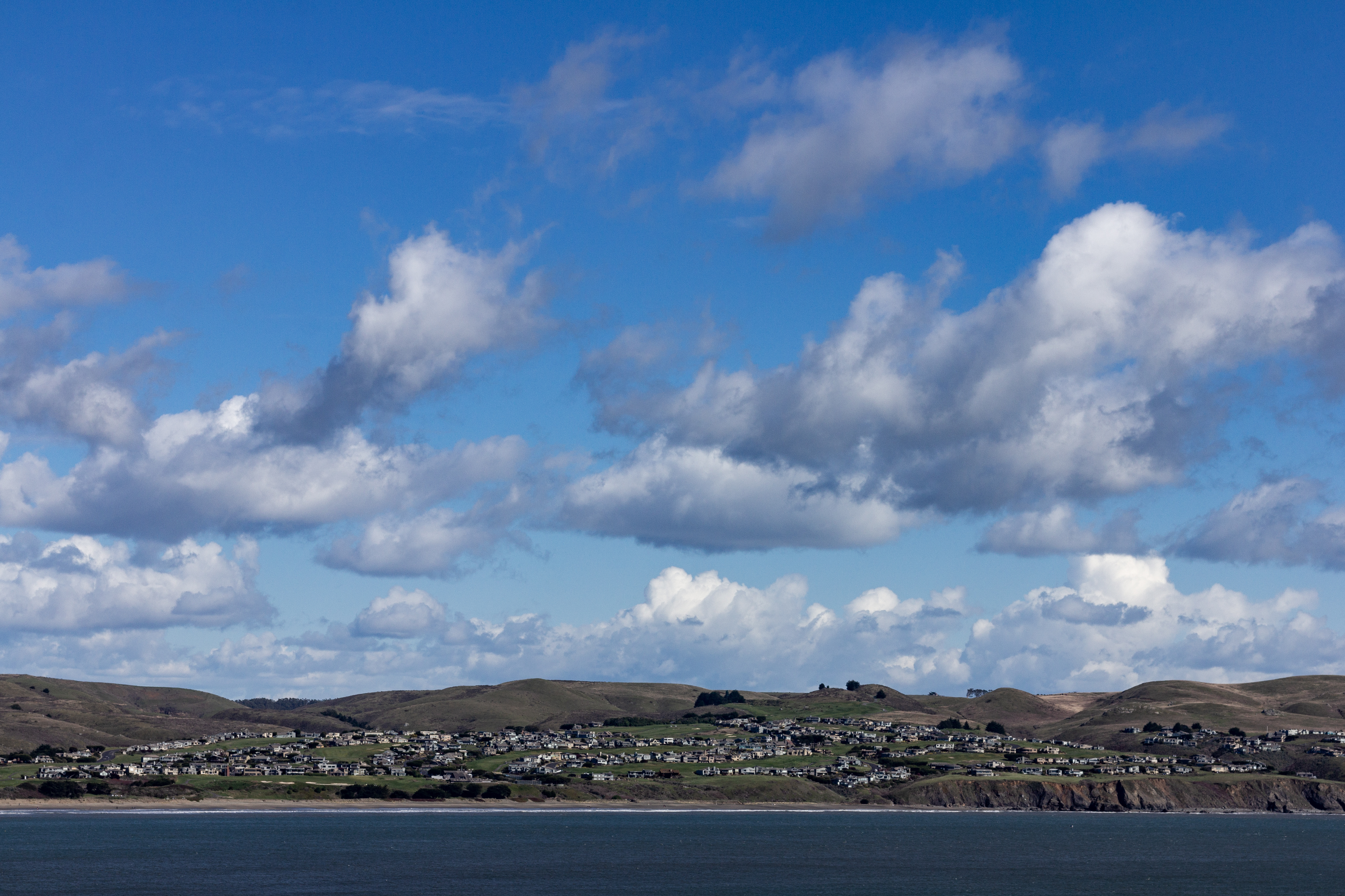 A photograph of many homes along the cost.