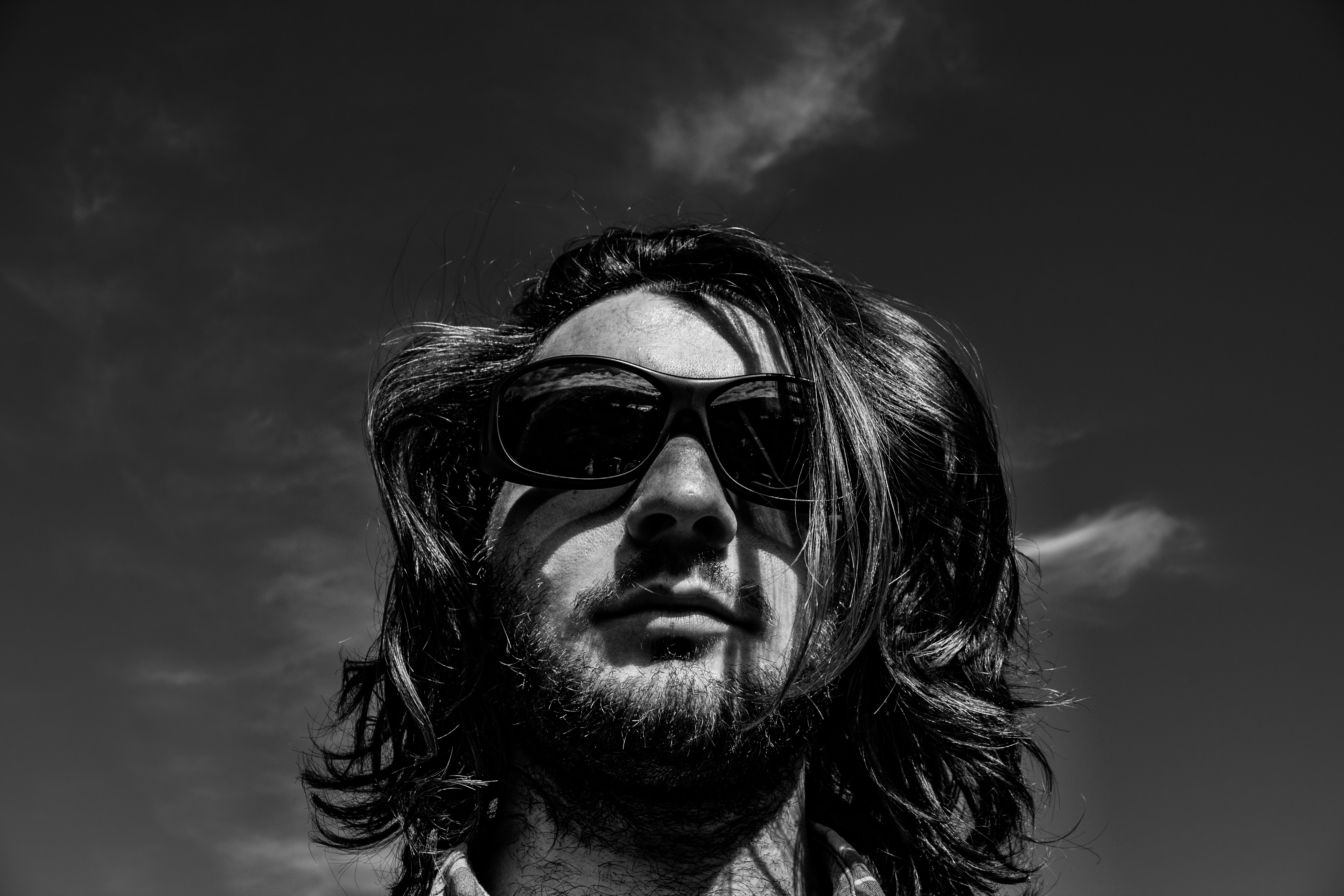 A photograph of a face wearing sunglasses.