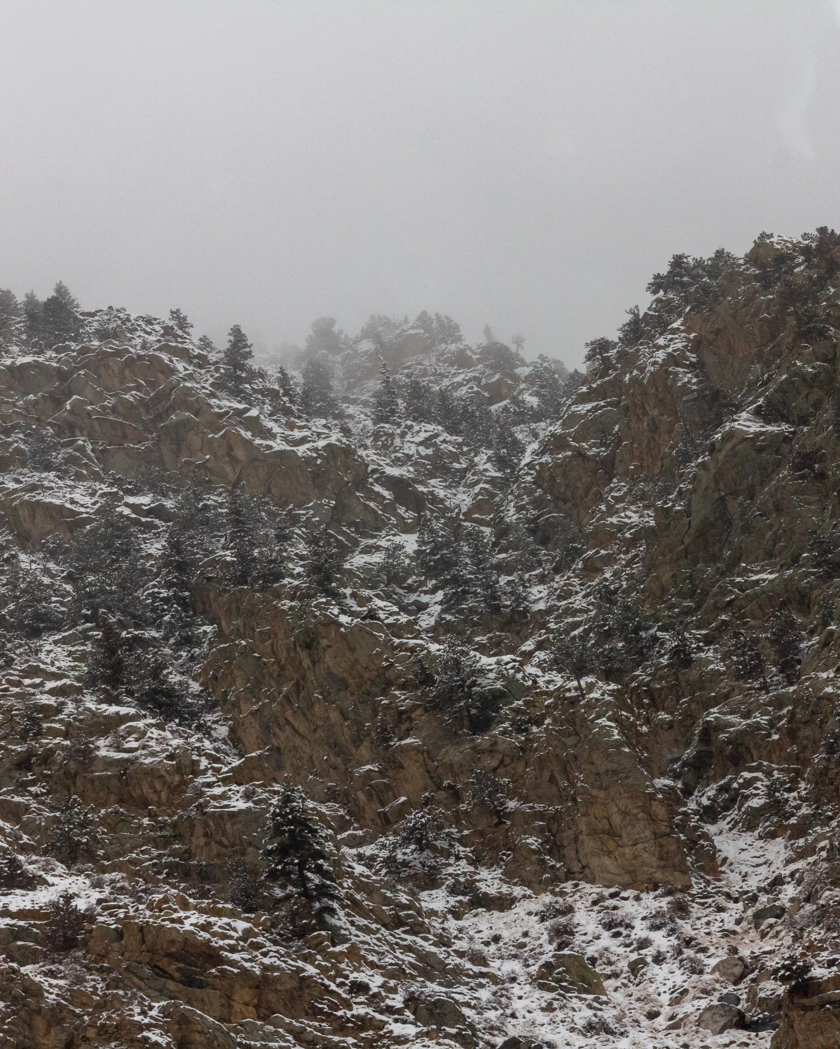 A photograph of some rocky cliffs in the snow.