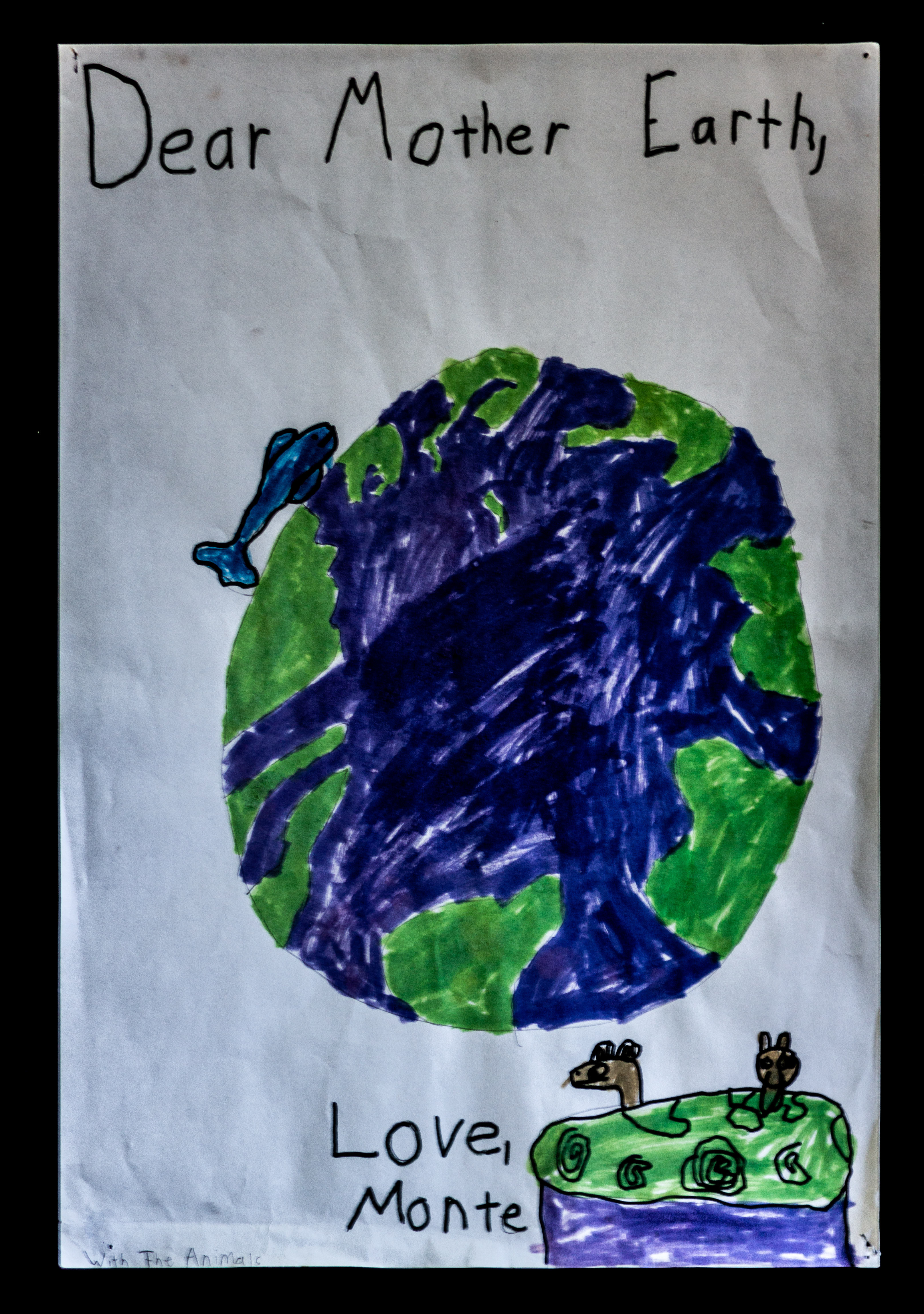 A drawing of the earth, with the words "Dear Mother Earth," written above, and "Love, Monte" written below.