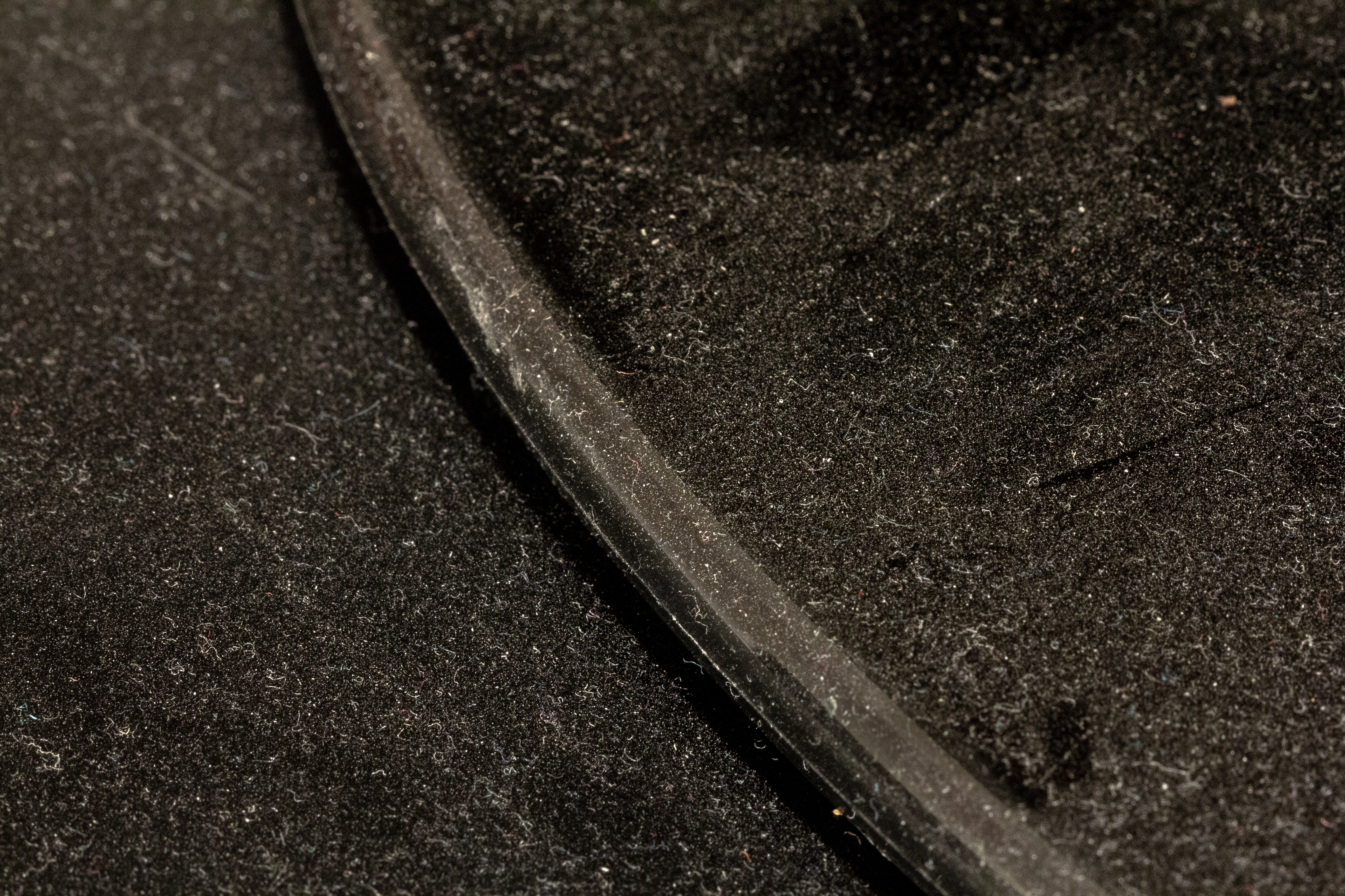 A photograph of some dust on a black surface.