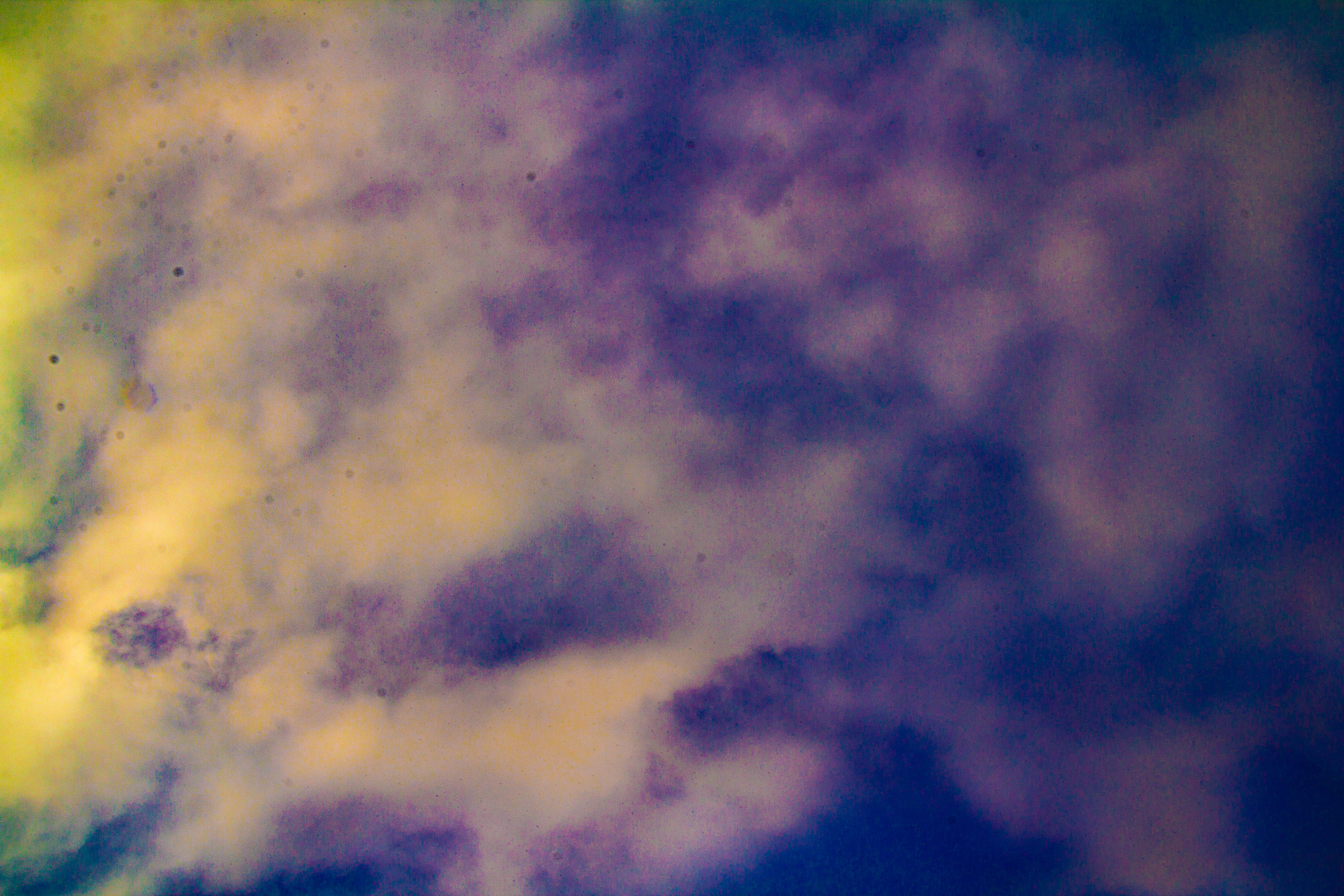 A photograph of some clouds, showing significant defects in the photograph itself.