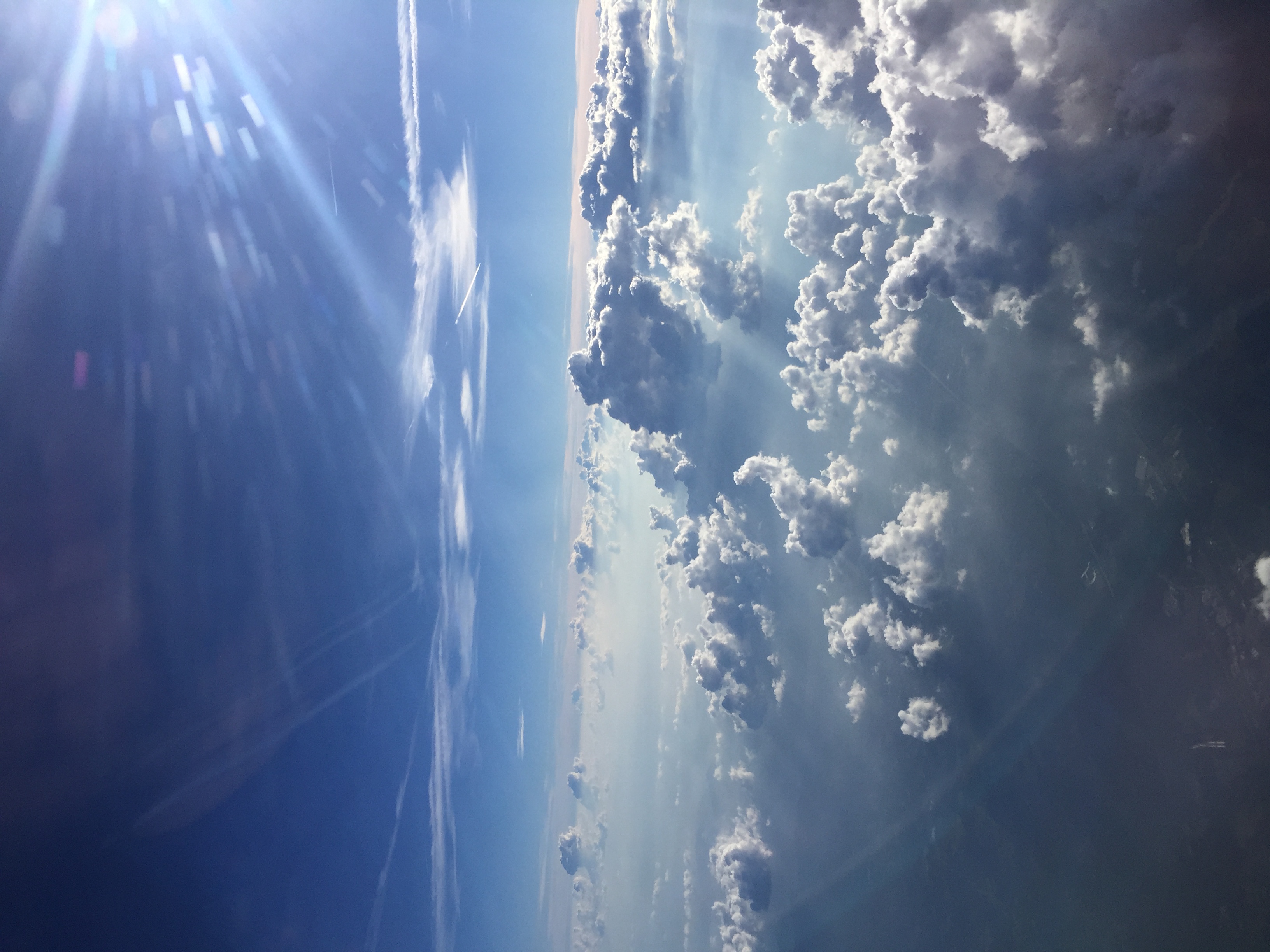 A photograph of many large clouds, floating below the viewer.