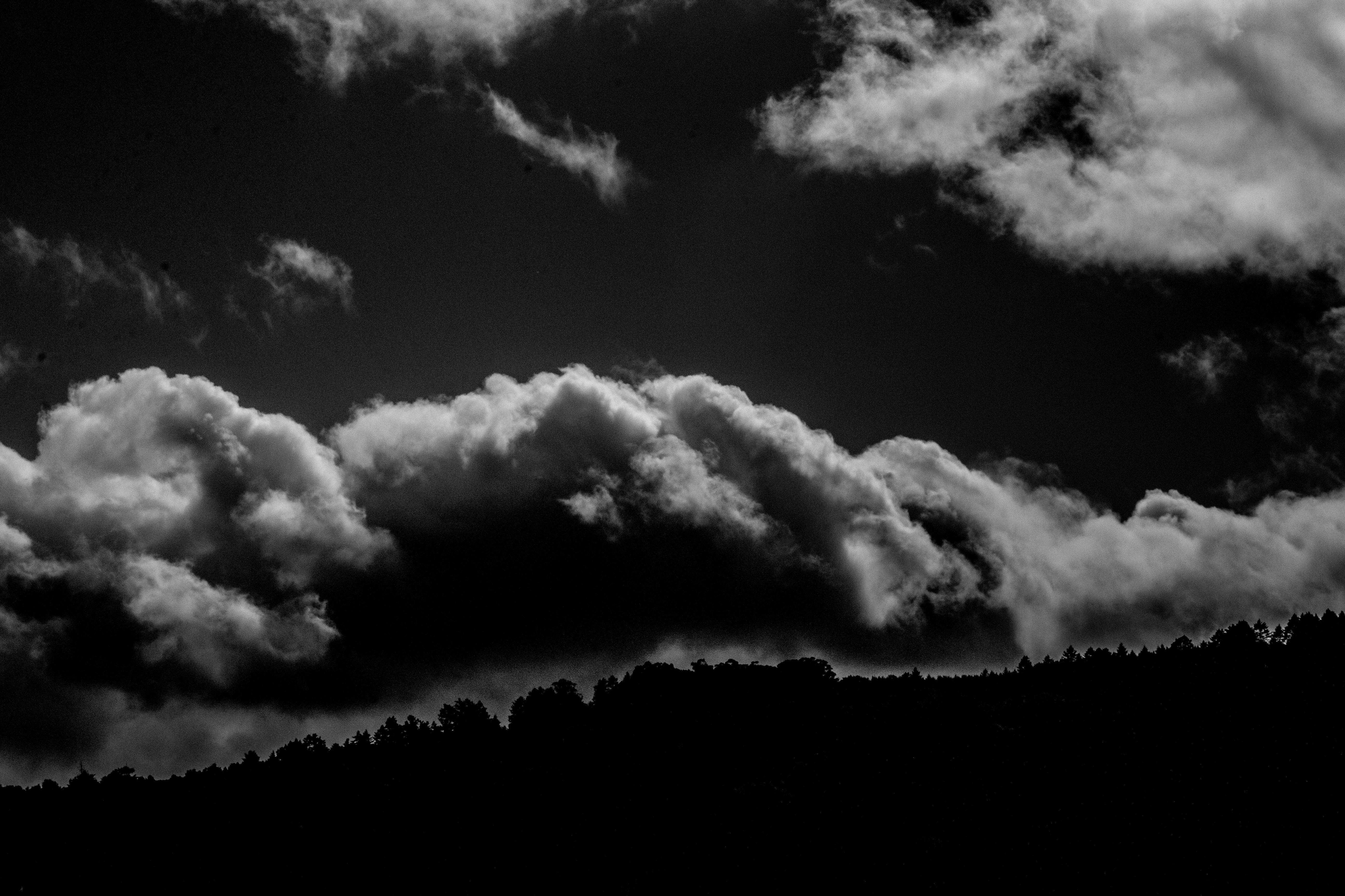 A photograph of a cloud over a mountainside.