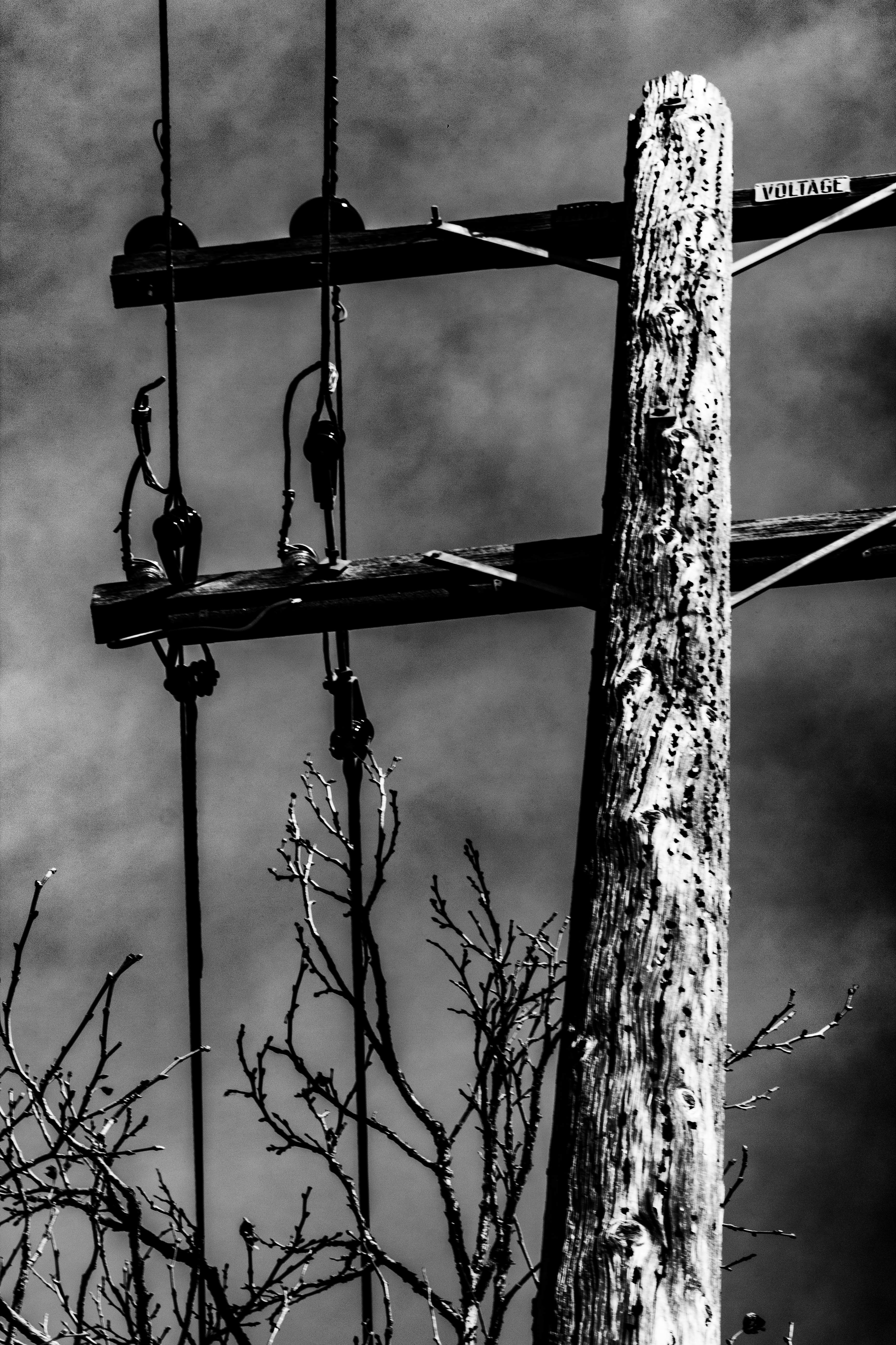 A photograph of the voltage sign on a power line.