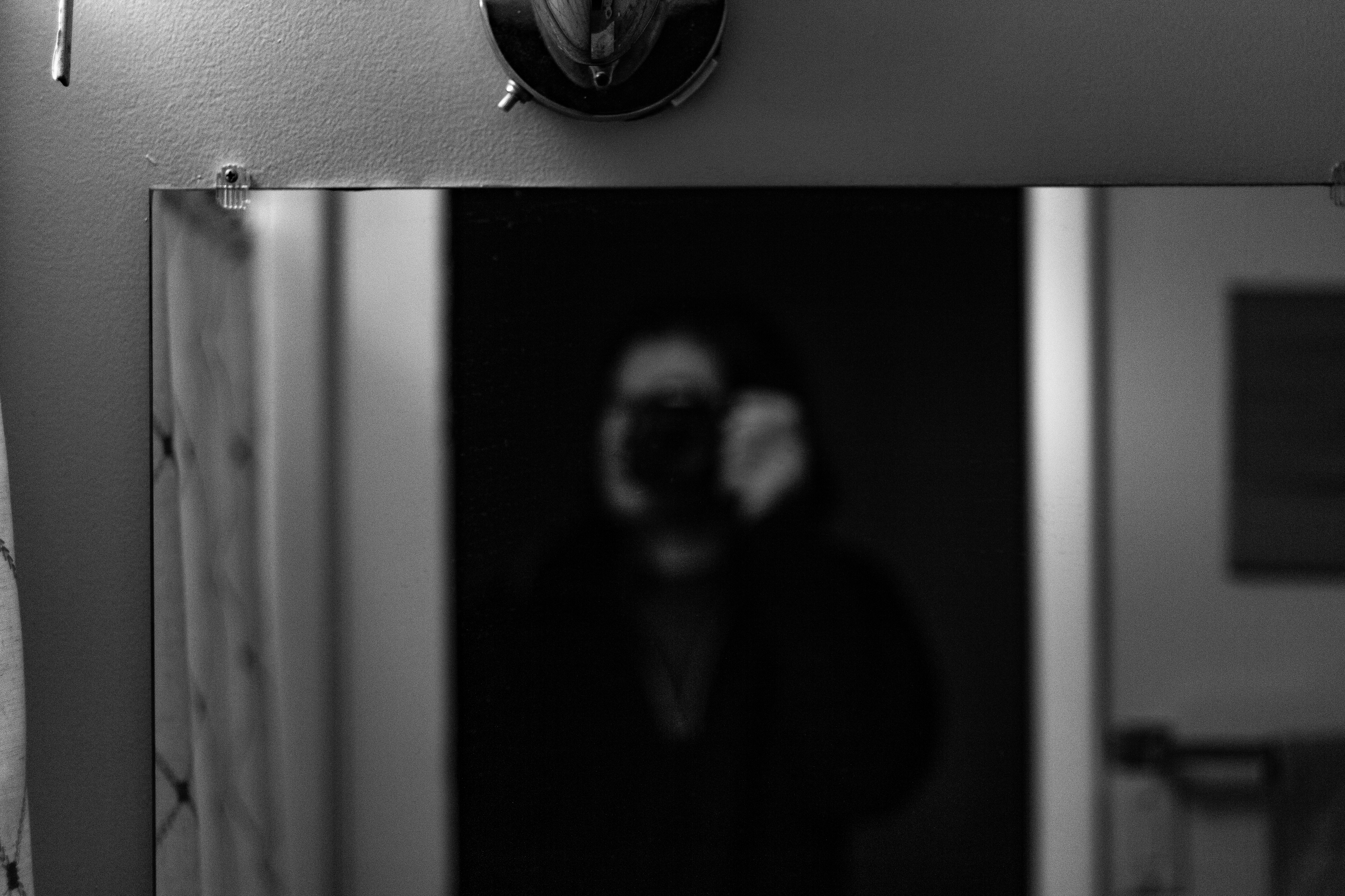 A photograph of a person taking a selfie in the mirror.