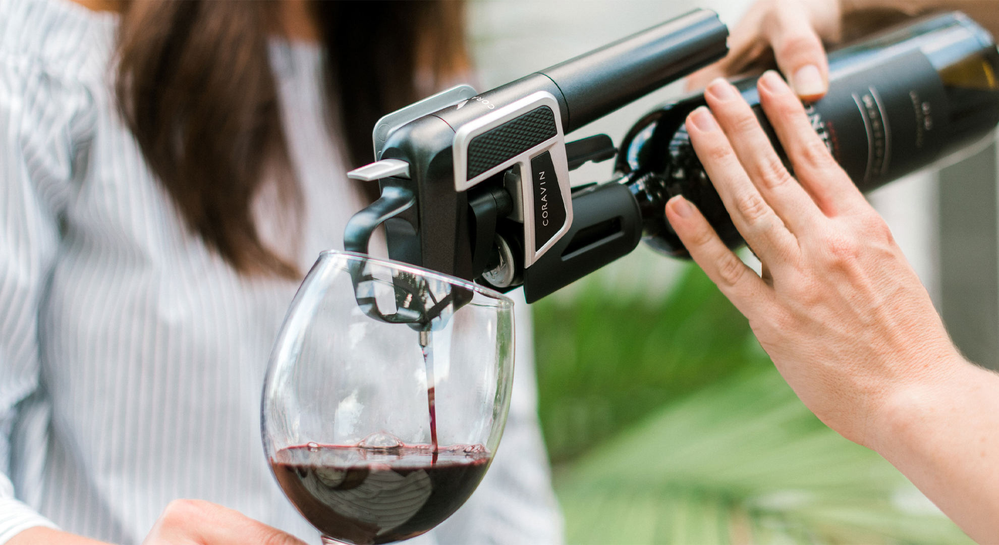 Red wine being poured into a glass using a Coravin Model Two.