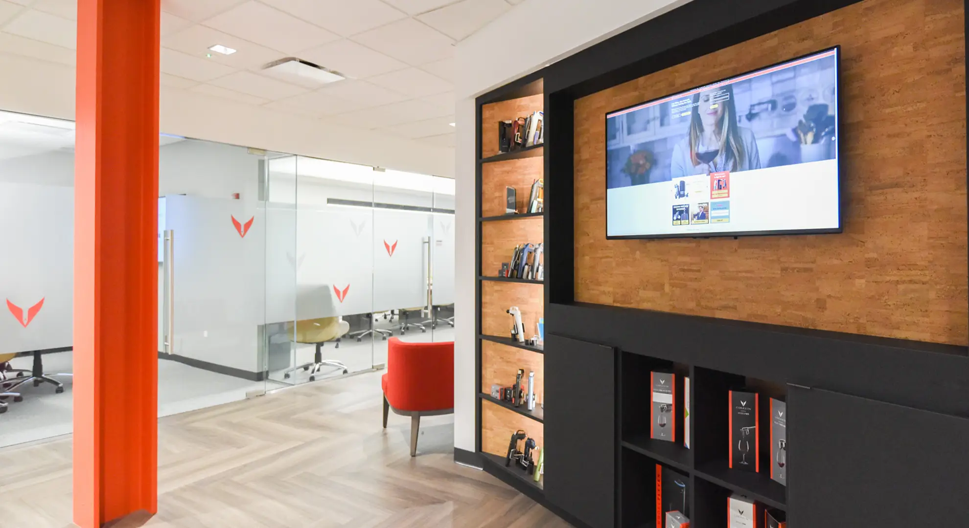 Office entryway setting with boardroom, awards display, and TV, at Coravin Headquarters.