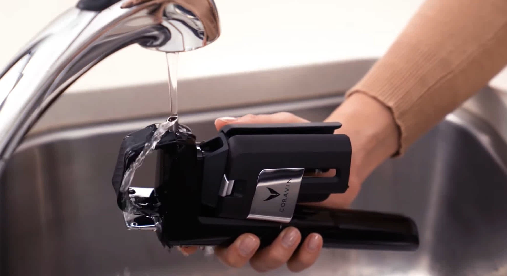 Coravin Model Six Wine Preservation System under a running tap
