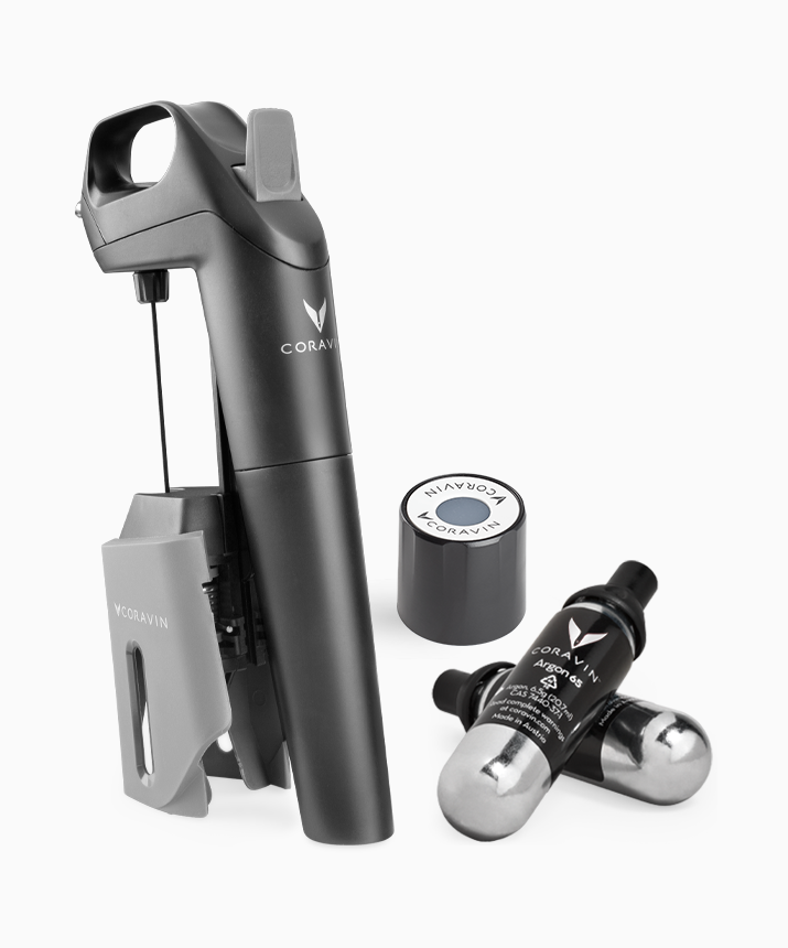 Product shot of the Coravin Model Three Wine Preservation System, one screw cap, and two Coravin Pure Capsules.