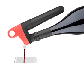 Product shot of the Pivot System in Coral pouring red wine into a glass.
