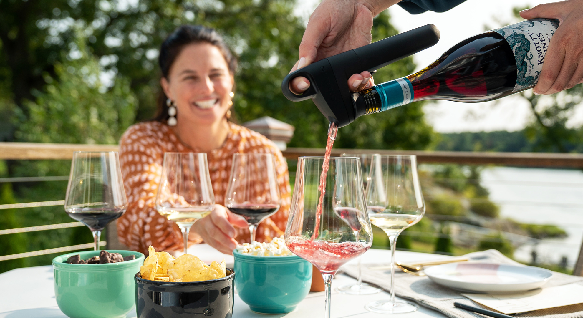 Pivot Wine Preservation System pouring with woman smiling in the background