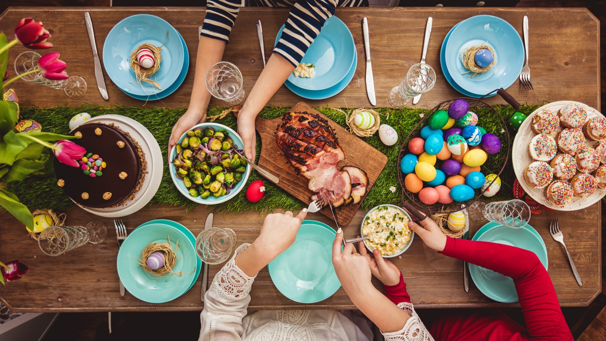 easter dinner photo with colored eggs ham and brussel sprouts