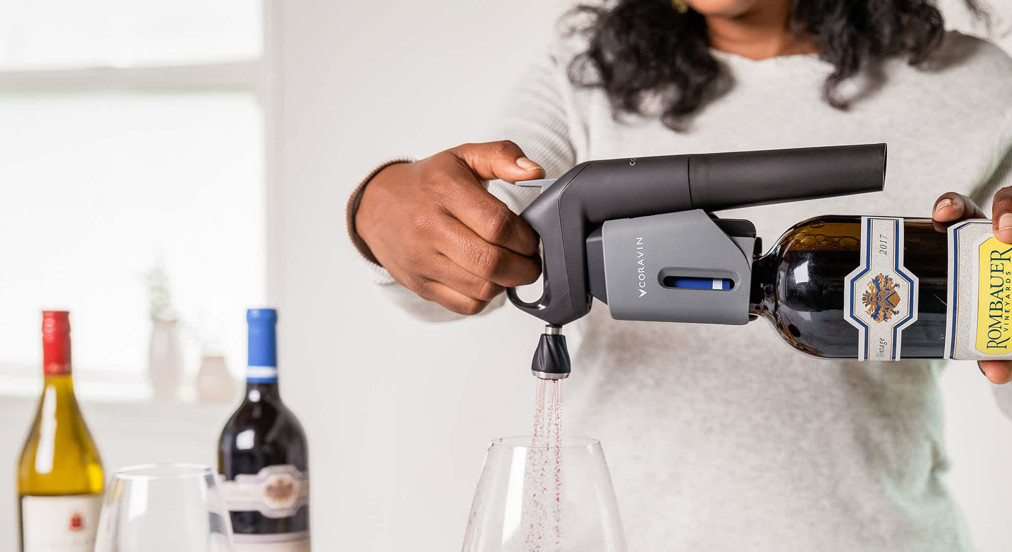 pouring red wine with the Coravin Aerator and Model Three Wine Preservation System