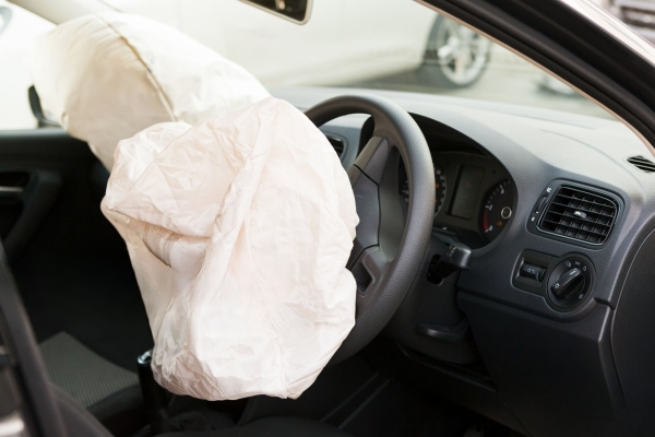 This image captures the interior of a car post-accident, showing the airbags fully deployed. It illustrates the airbags' crucial role in cushioning the impact for passengers, highlighting the effectiveness of vehicle safety systems in real-world scenarios.