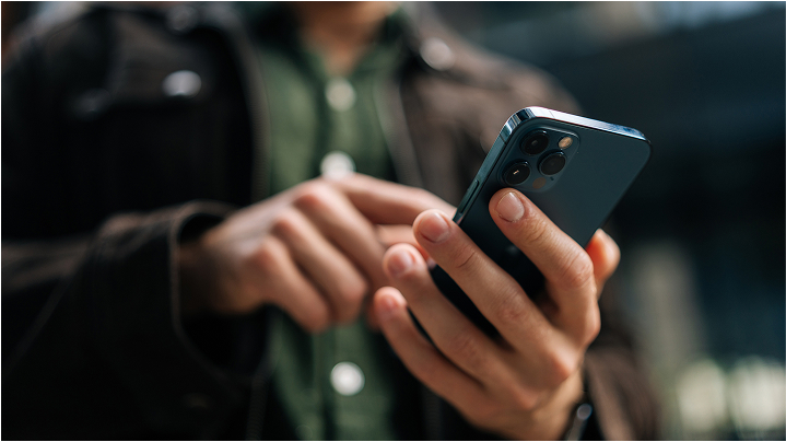 Close up of hands holding cell phone