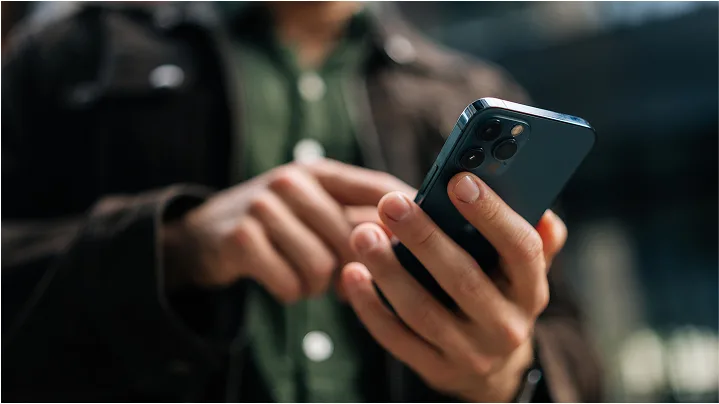 Close up of hands holding cell phone