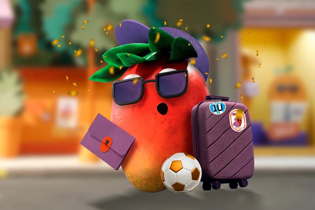 El personaje Manguito de Naranja X posa con una pelota de fútbol y una valija.