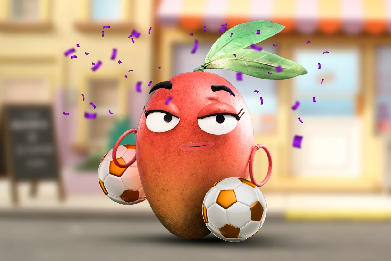 El personaje Manguito de Naranja X posa junto a dos pelotas de fútbol