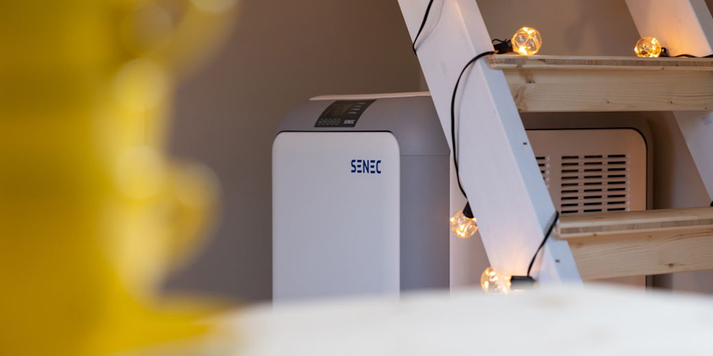 SENEC Stromspeicher für Solaranlagen unter einer Holztreppe.