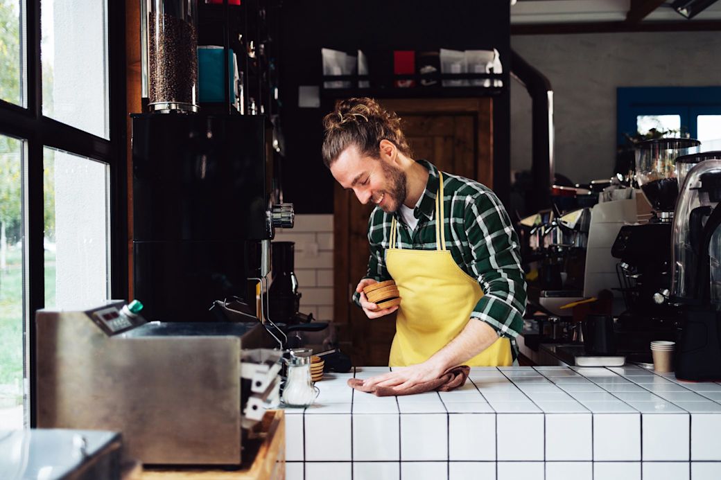Mann im Cafe vor Barista Maschinen bereitet Kaffee für Kunden und Gäste vor