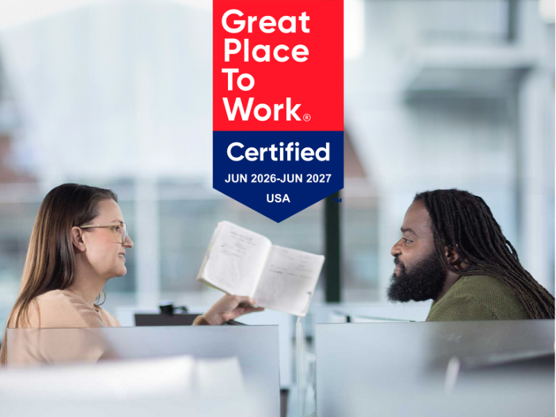 Quadient Great Place To Work Certified badge with two colleagues collaborating in a modern office setting