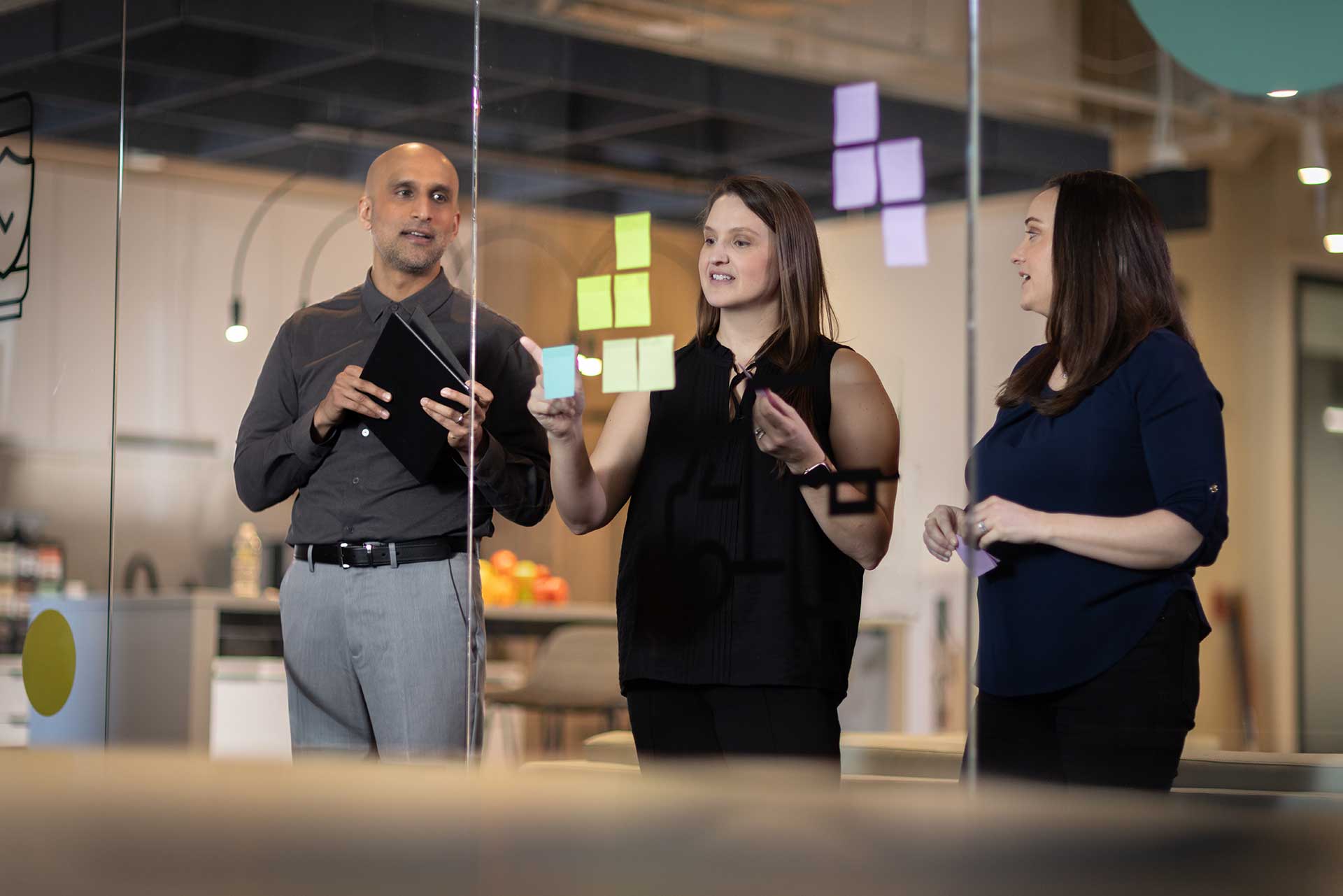 Three people working together collaborating on a project