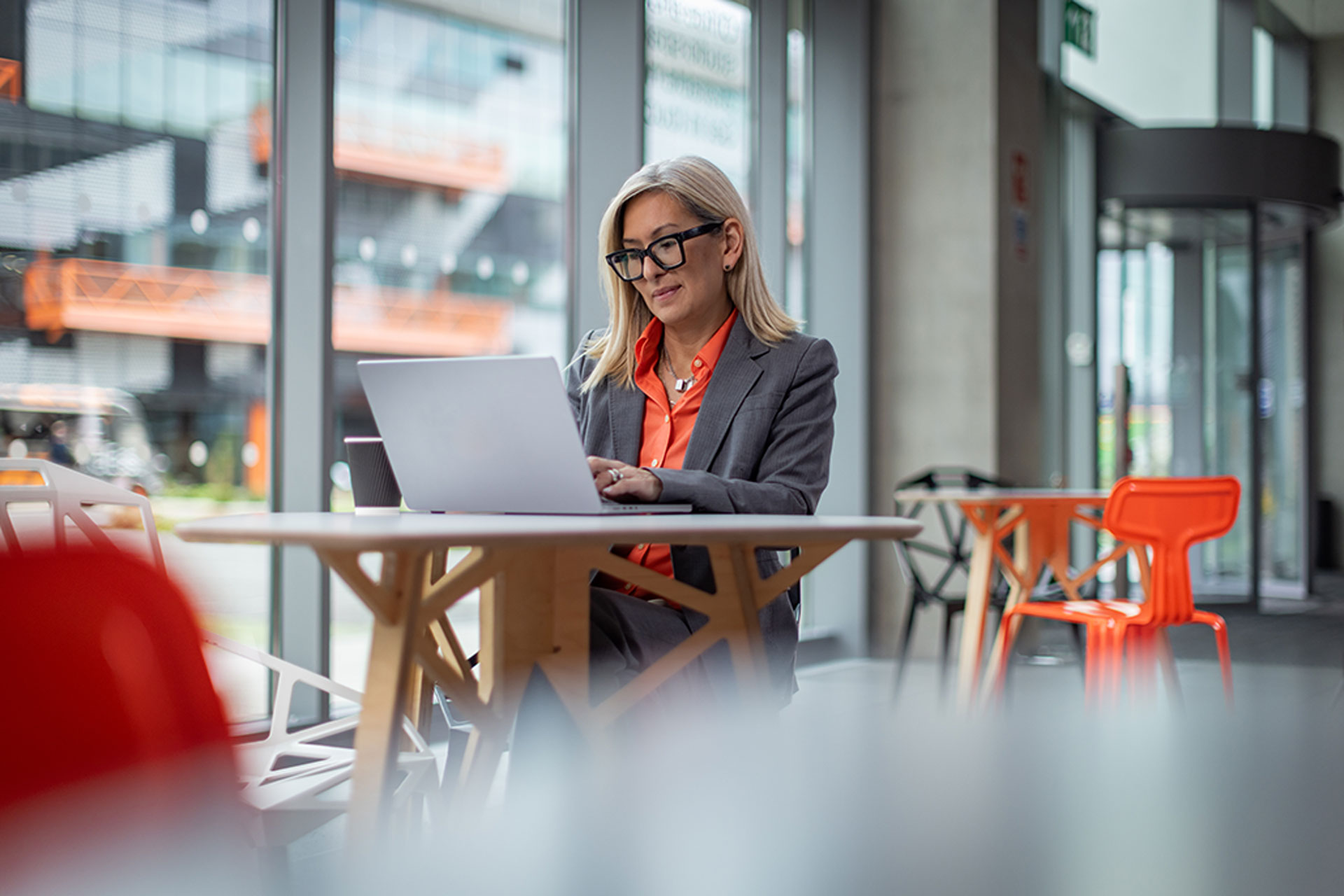Business woman working at laptop in a shared space