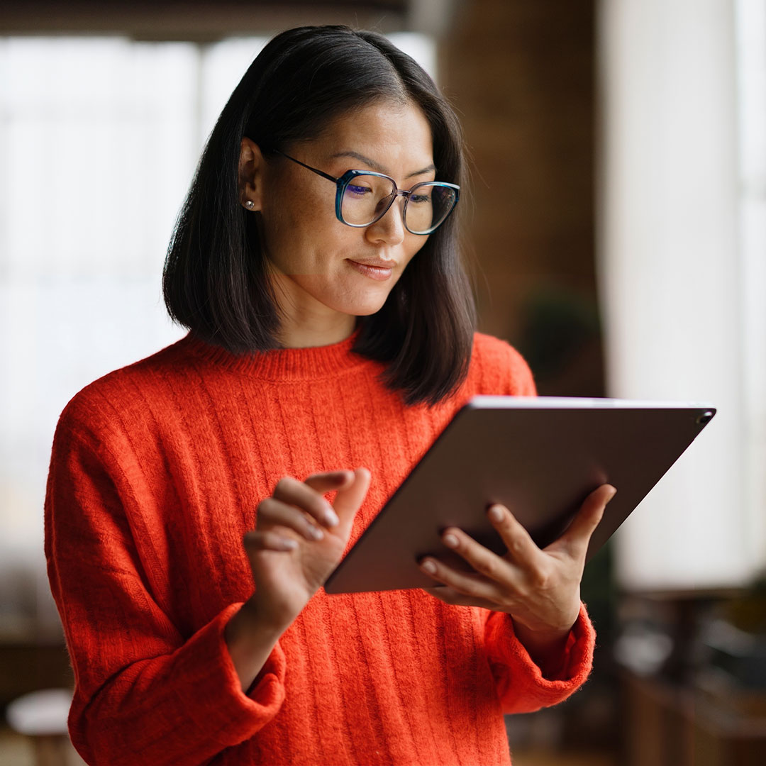 Woman reading tablet studying a report